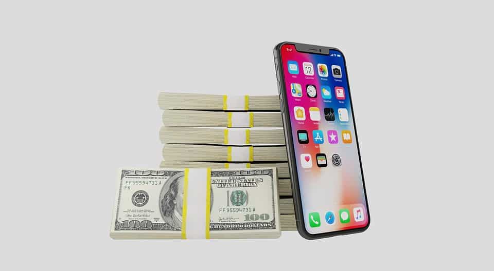bundles of cash next to a cell phone
